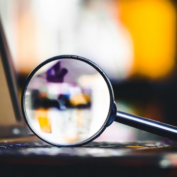 advanced system repair system optimizer magnifying glass on laptop keyboard